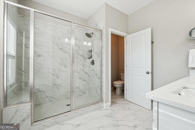 bathroom with a shower with shower door and vanity