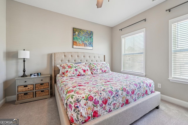 bedroom featuring ceiling fan and light carpet