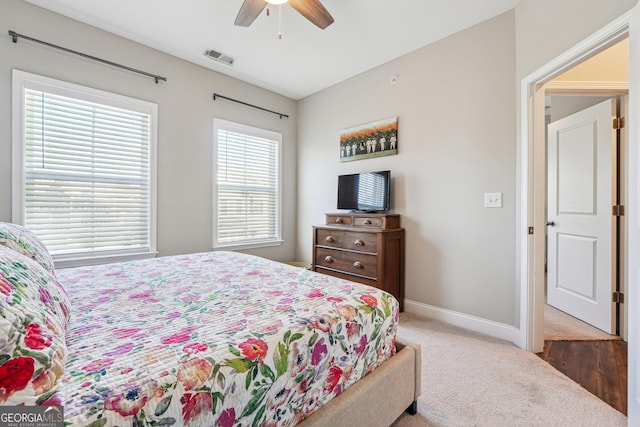 bedroom featuring ceiling fan and dark carpet