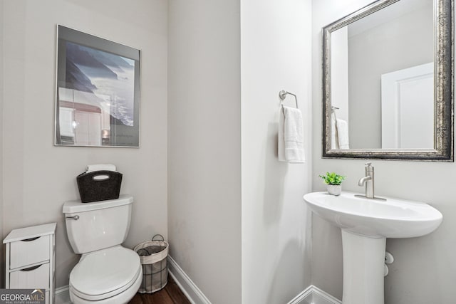 bathroom featuring toilet and hardwood / wood-style floors