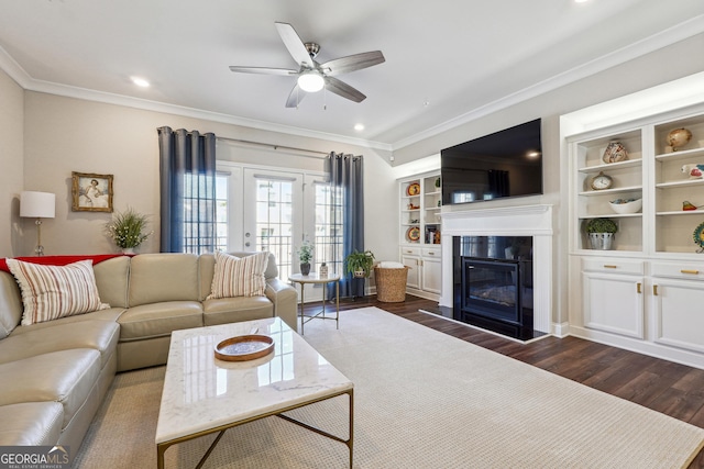 living room featuring ceiling fan, dark hardwood / wood-style flooring, ornamental molding, and french doors