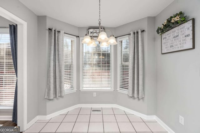 unfurnished dining area featuring light tile patterned floors and a notable chandelier