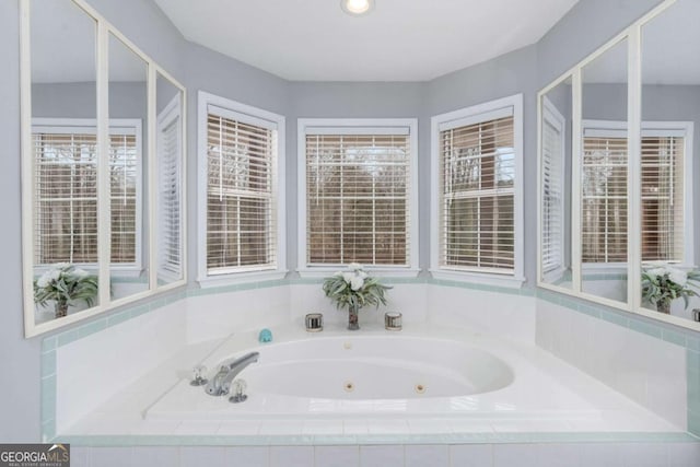 bathroom featuring tiled tub