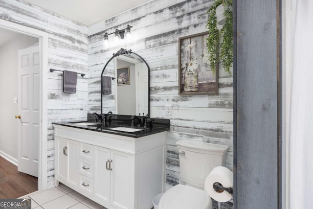 bathroom featuring tile patterned flooring, vanity, and toilet