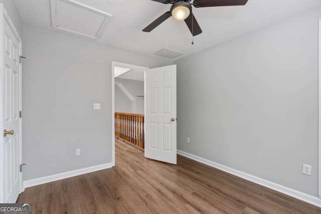 unfurnished bedroom with ceiling fan and hardwood / wood-style flooring