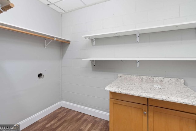 laundry area with dark wood-type flooring