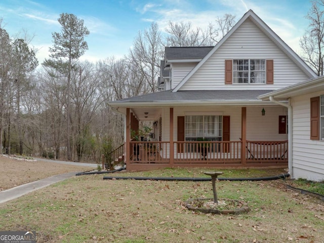 view of front of property with a front yard and covered porch