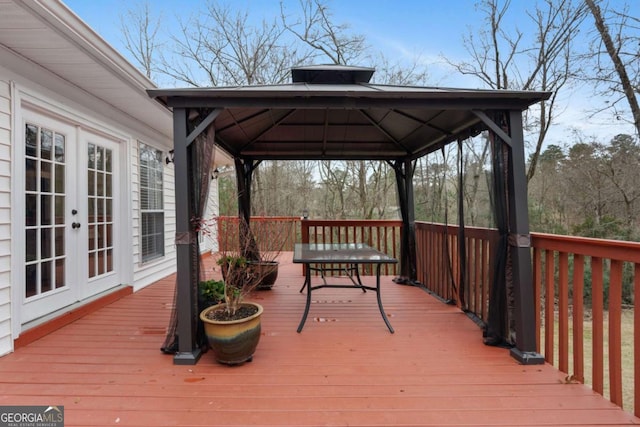 wooden deck with a gazebo and french doors