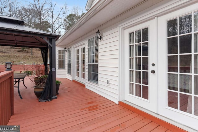 deck featuring a gazebo and french doors