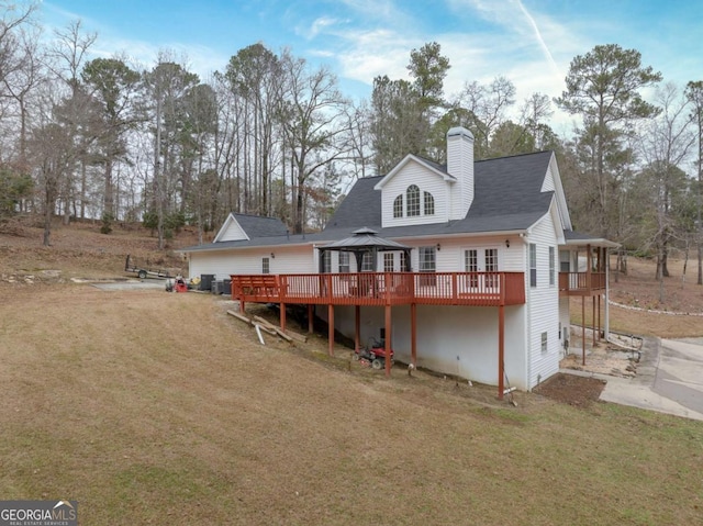 rear view of house featuring a gazebo, a yard, and a wooden deck