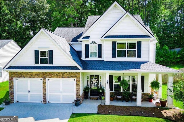 view of front of property with covered porch and a garage