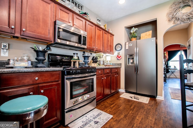 kitchen featuring appliances with stainless steel finishes and dark hardwood / wood-style flooring