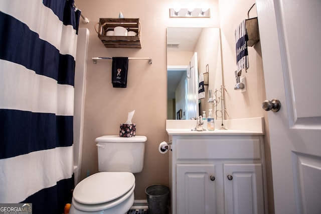 bathroom featuring a shower with curtain, vanity, and toilet