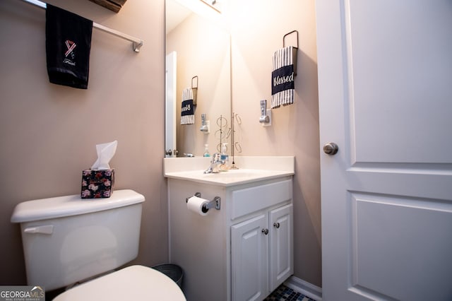 bathroom featuring vanity and toilet