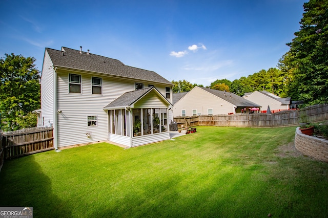 back of house featuring a sunroom and a yard