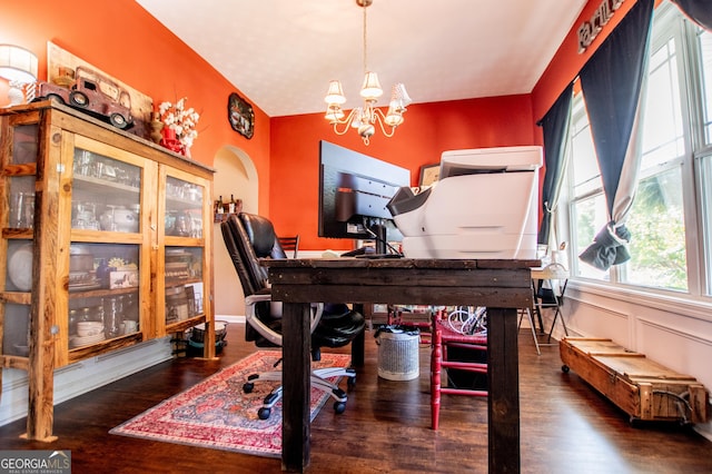 office area featuring a notable chandelier and dark hardwood / wood-style flooring