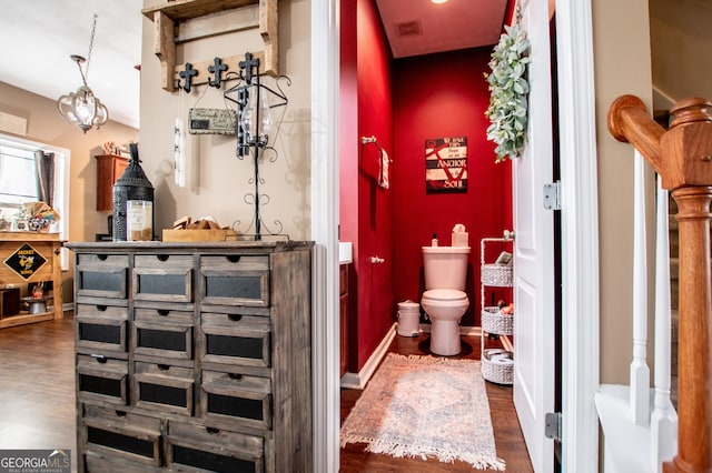 bathroom featuring hardwood / wood-style floors and toilet