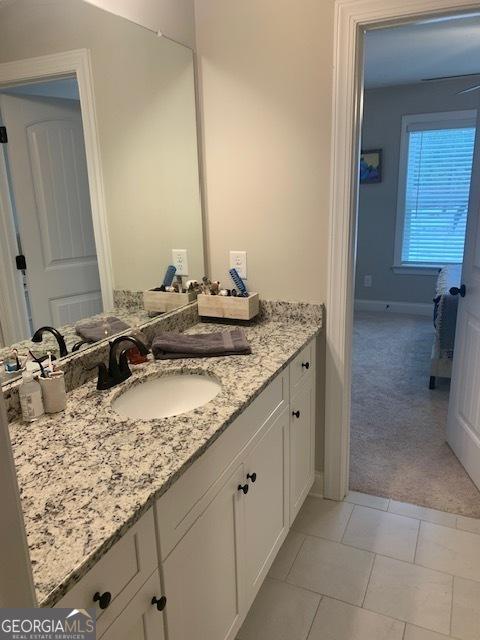 bathroom featuring tile patterned flooring and vanity