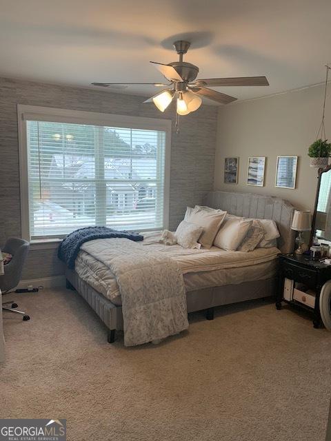 carpeted bedroom with ceiling fan