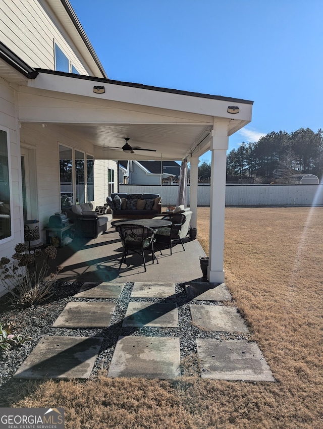 view of patio with outdoor lounge area and ceiling fan