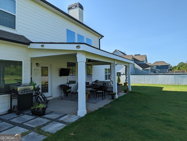 back of house featuring a patio area and a yard