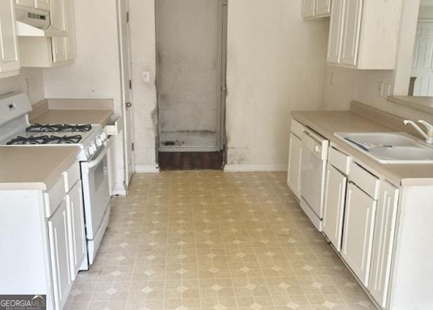 kitchen featuring white cabinets, white appliances, sink, and range hood