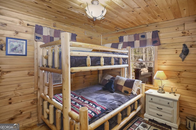 bedroom featuring wooden ceiling and wooden walls