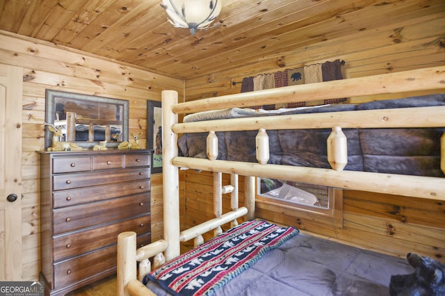 bedroom featuring wooden ceiling and wood walls