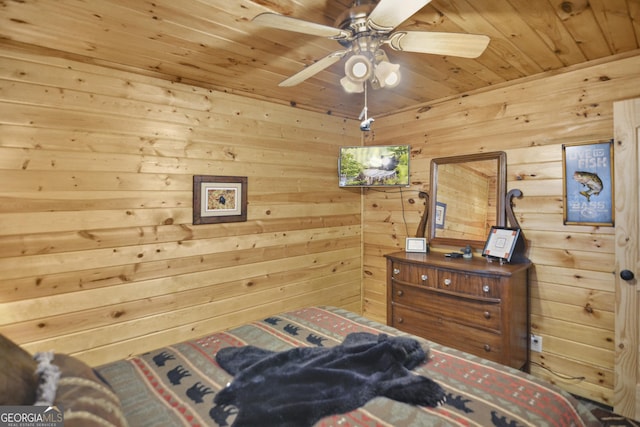 bedroom with wood walls, ceiling fan, and wood ceiling