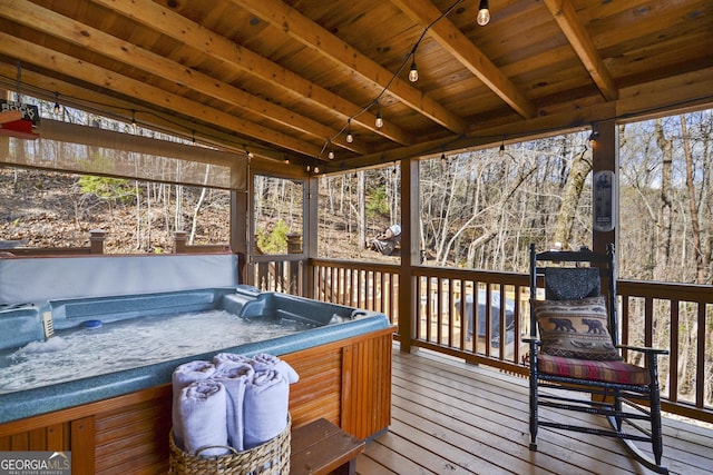 wooden terrace with a hot tub