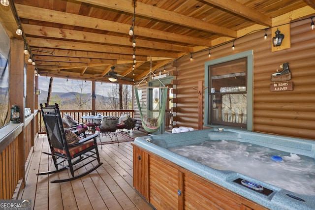 wooden terrace featuring a hot tub