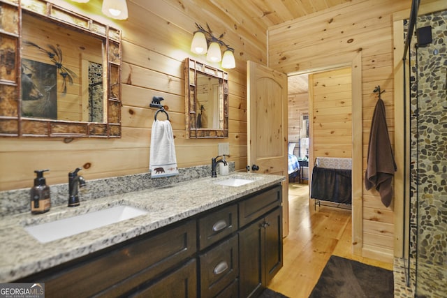 bathroom with wooden walls, vanity, wood-type flooring, and wooden ceiling