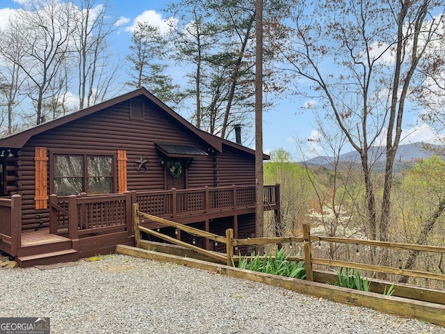 exterior space with a deck with mountain view