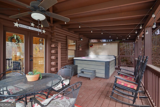 deck with a hot tub and ceiling fan