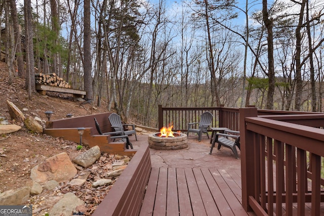 wooden terrace with a fire pit