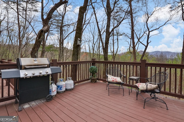 wooden terrace with area for grilling and a mountain view