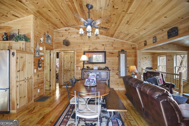 dining space with hardwood / wood-style floors, wooden ceiling, and vaulted ceiling