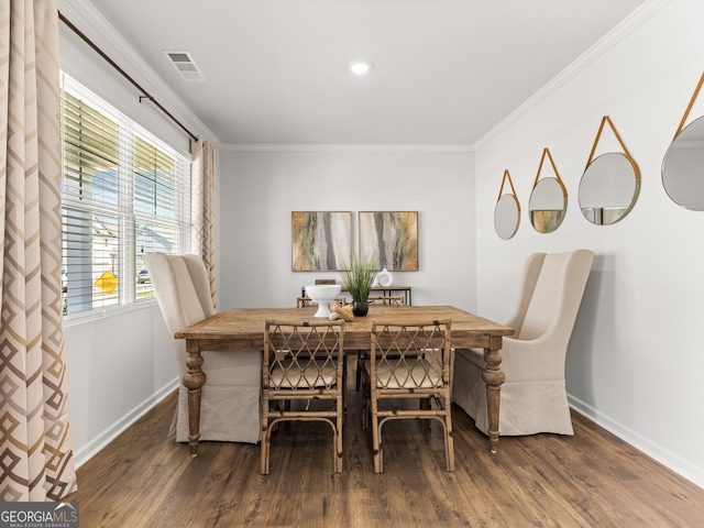 dining area with crown molding and dark hardwood / wood-style flooring