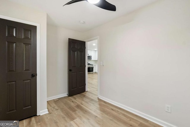 interior space with ceiling fan and light wood-type flooring