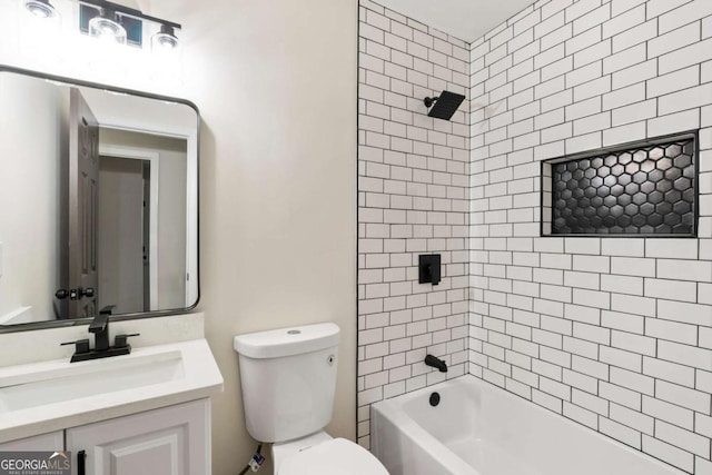 full bathroom with toilet, vanity, and tiled shower / bath