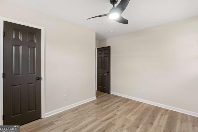 unfurnished bedroom featuring light wood-type flooring and ceiling fan