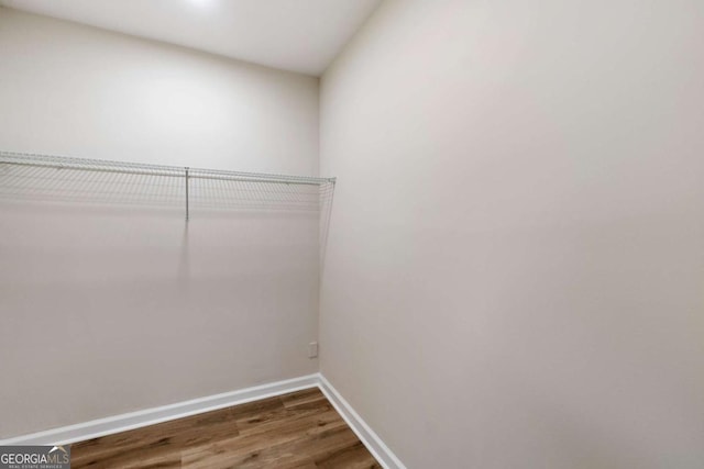 spacious closet featuring hardwood / wood-style floors