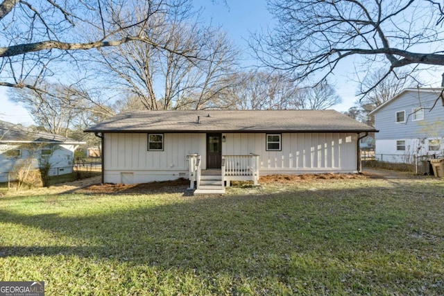 back of house featuring a yard