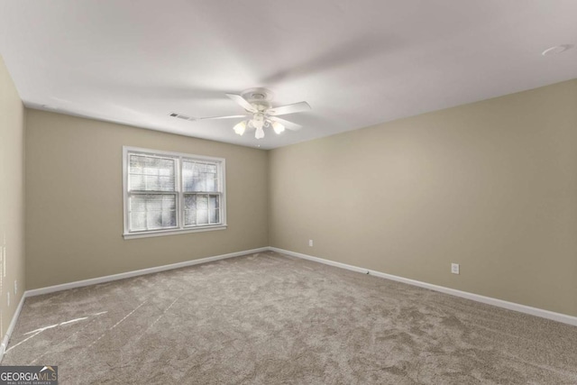 carpeted empty room featuring ceiling fan