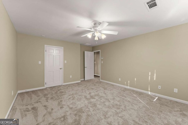 unfurnished bedroom with ceiling fan and light colored carpet