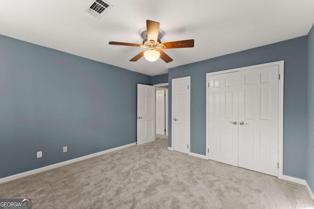 unfurnished bedroom with ceiling fan and light carpet