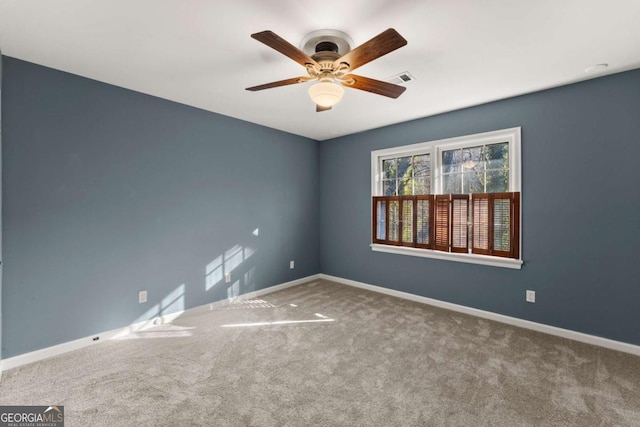 empty room featuring carpet and ceiling fan