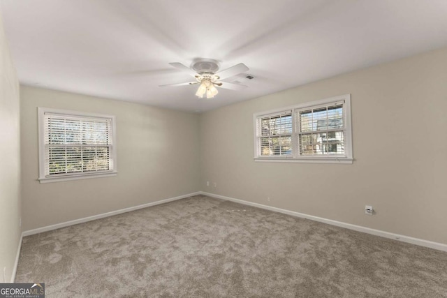 unfurnished room with ceiling fan, plenty of natural light, and light colored carpet