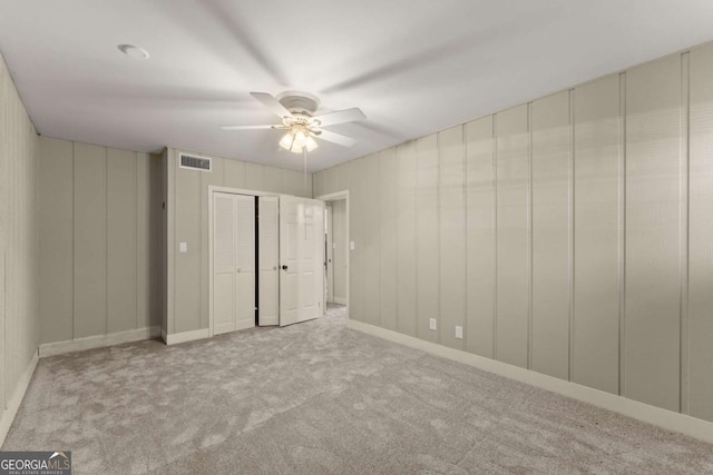 unfurnished bedroom with ceiling fan and light carpet