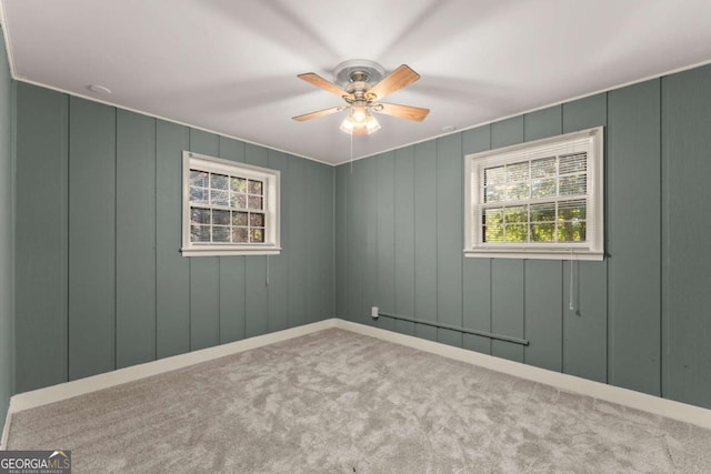 empty room with ceiling fan and light colored carpet